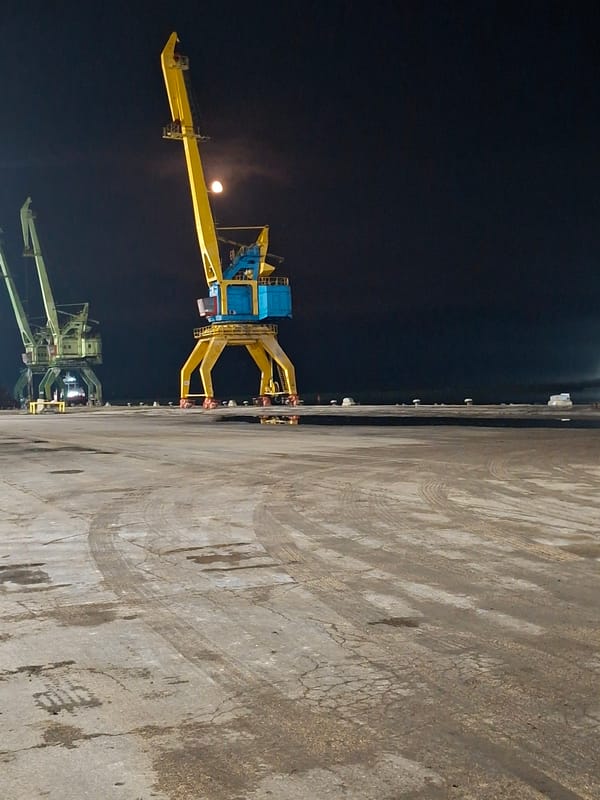 Nighttime cargo operations documented at unidentified industrial port