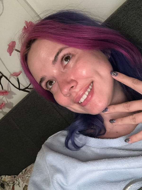 Woman takes colorful-haired selfies on Zagreb couch