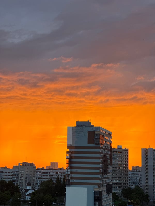 Fiery sunset burns across a city skyline