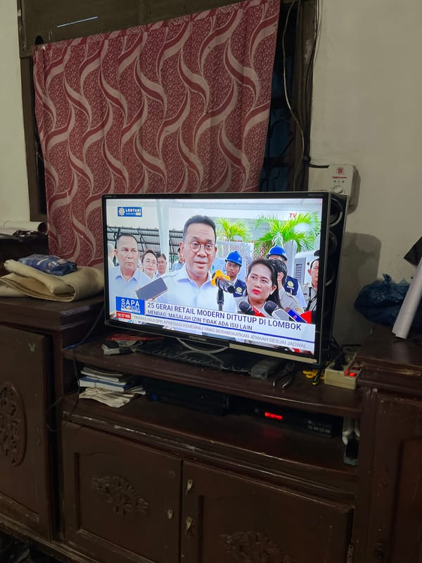Indonesian resident documents cooking, news watching during rainy morning
