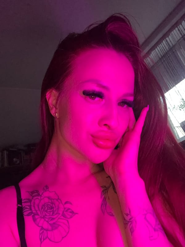 Woman takes selfies under colored lighting in Simferopol residence
