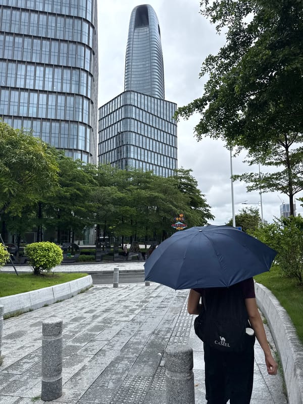 Wet streets and glass towers in Haizhu District after morning rain