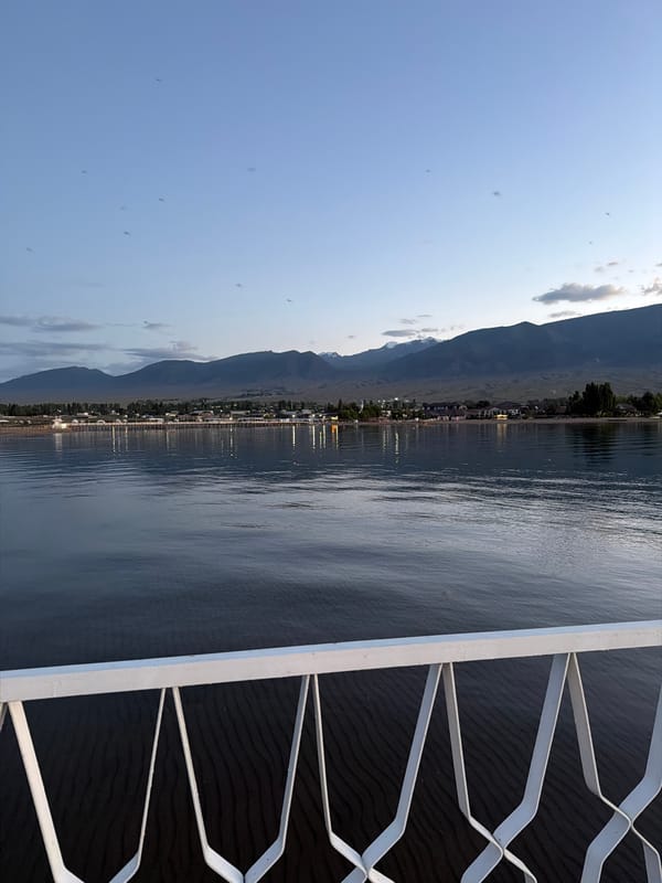 Lakeside pier at golden hour, coffee and calm water