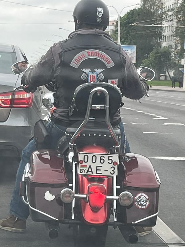 Motorcyclist stops in Minsk traffic during morning hours