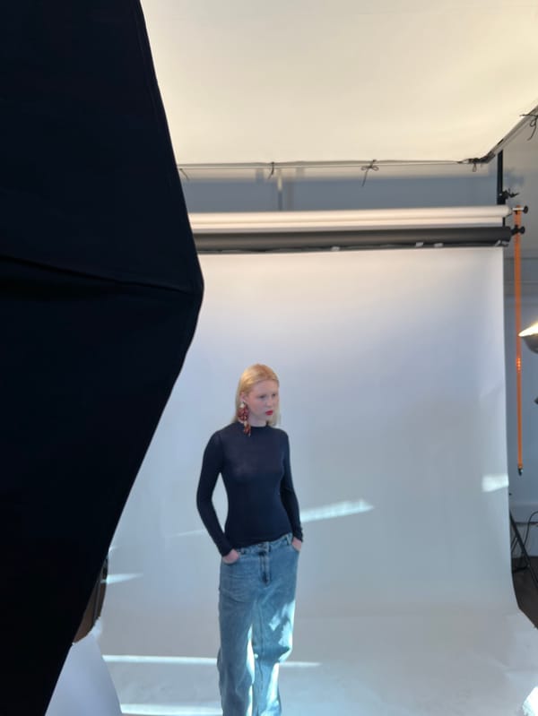Photography studio session documented in Paris with model and crew