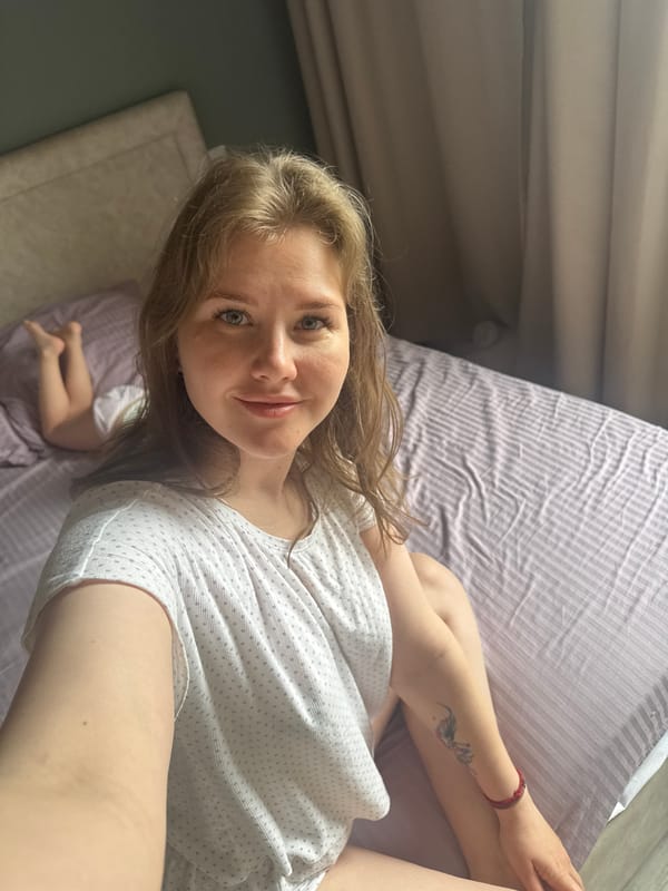 Mother and child rest in bed Sunday morning