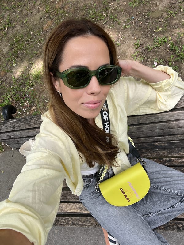 Woman enjoys morning Starbucks drink on Belgrade park bench
