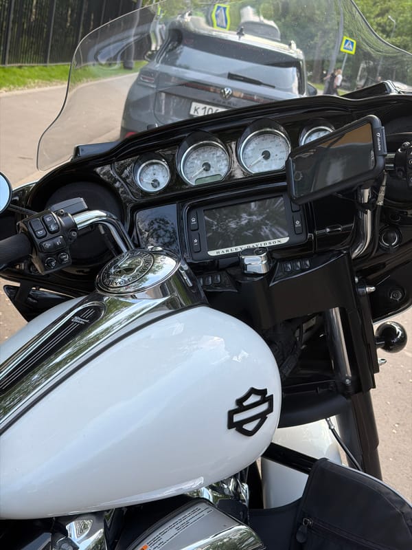 Harley-Davidson motorcycle parked beside Opel car in Moscow