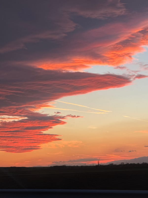 Dramatic sunset clouds with contrails observed in Malenovo, Bulgaria