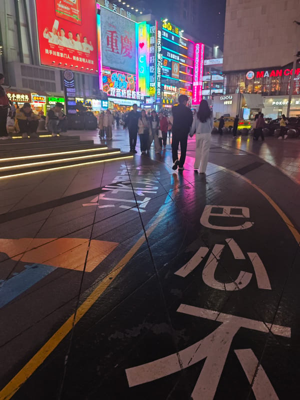 Nighttime commercial district bustling with food vendors, shoppers