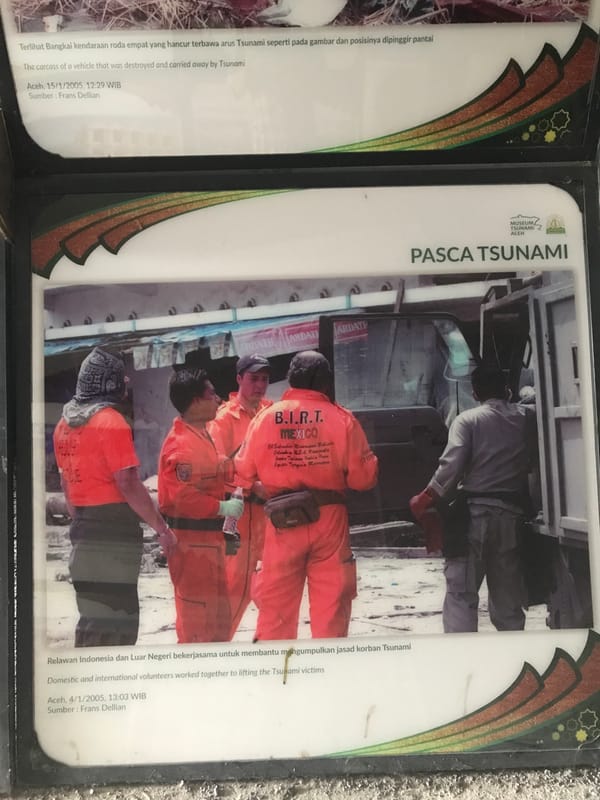 Visitor documents tour of Aceh Tsunami Museum memorial exhibits