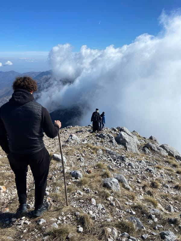 Hikers traverse snowy mountain ridges in Montenegro countryside