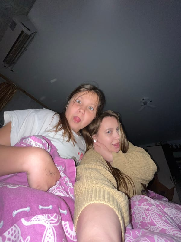 Mother and daughter take playful selfies in Russian home