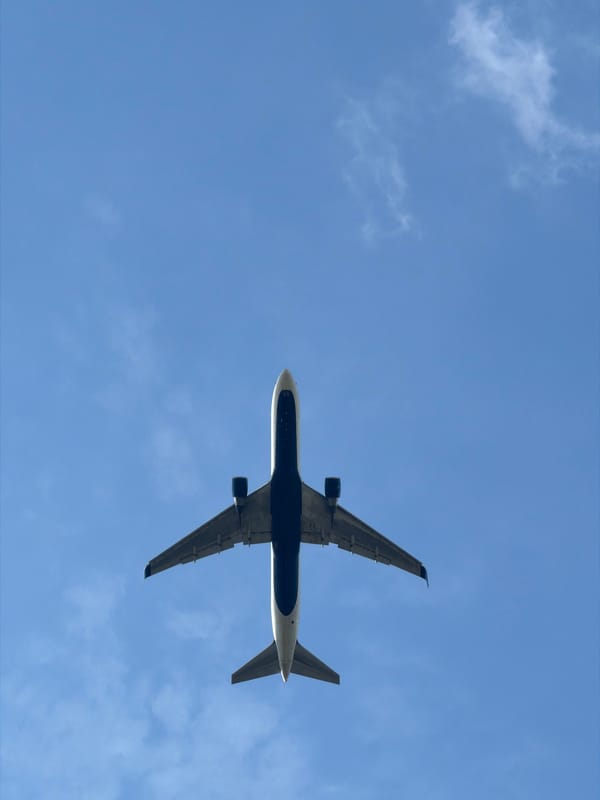 Commercial jet climbs low overhead near Prague, landing gear still down