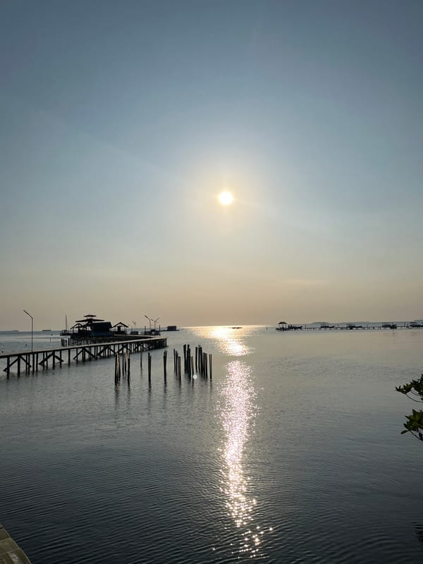 Low sun over still coastal waters in Kemloko, Indonesia
