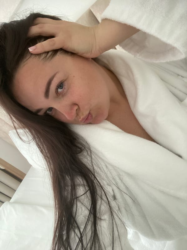Woman relaxes with drink in Sochi hotel room