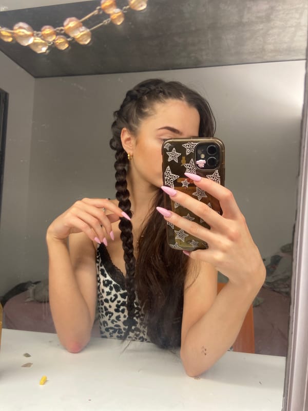 Woman takes mirror selfie in leopard print top, London