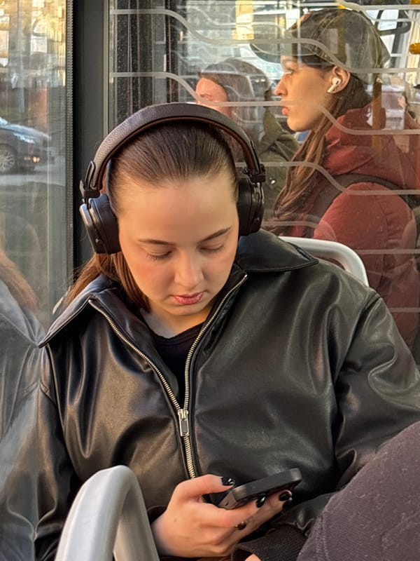 Woman uses smartphone during public transit commute in Perm