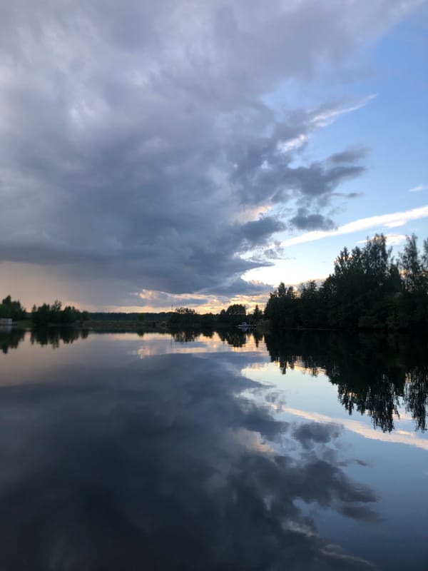Dramatic summer sky and water along the Svir River at dusk