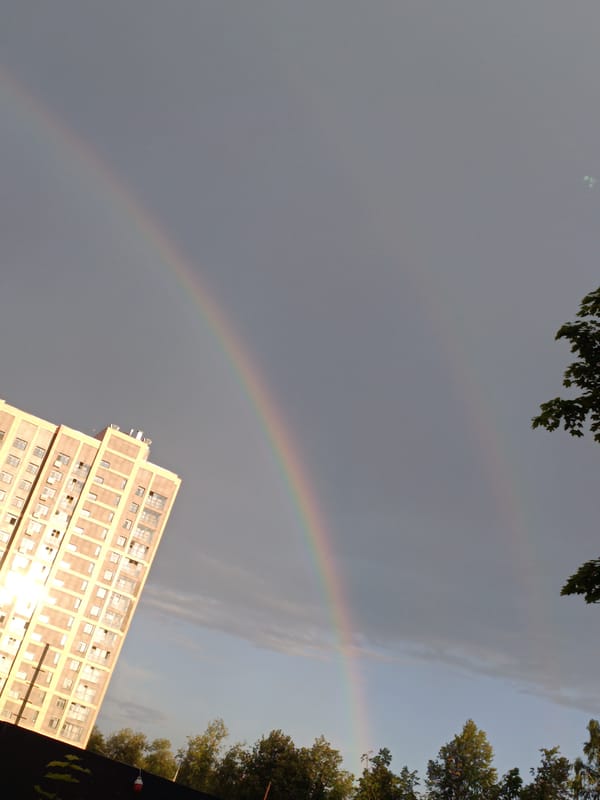 Double rainbow over the city, caught from five angles