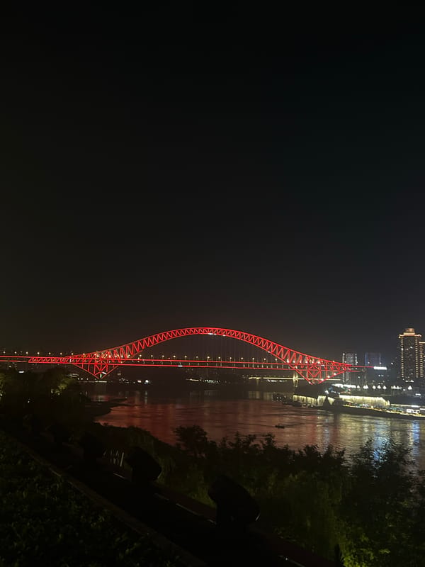 Hongya Cave Bridge glows red against the Chongqing night sky