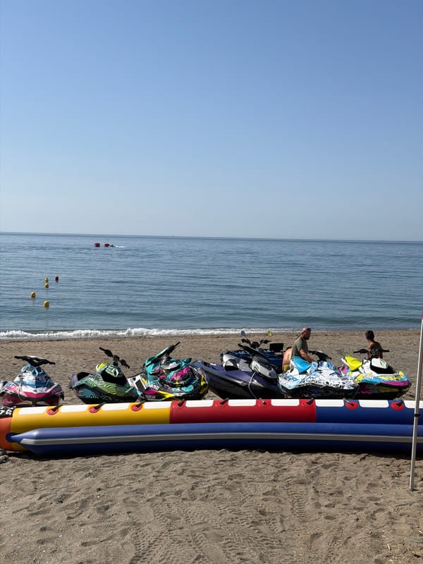 Summer morning on the Estepona coast: water sports, history, and smoke