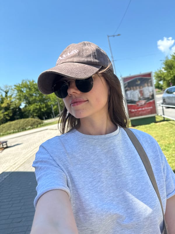 Woman takes selfie near adult shop in Siófok, Hungary