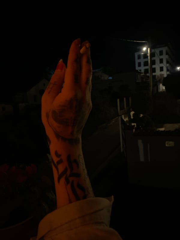 Tattooed woman smoking cigarette in urban night setting