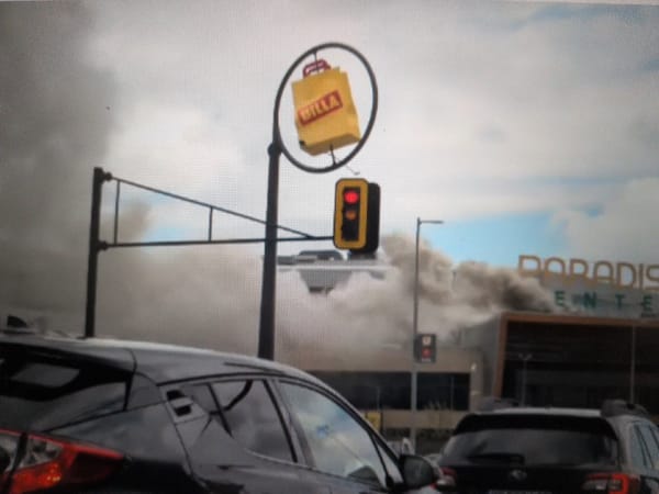 Smoke billows from Paradise Center mall, traffic stops