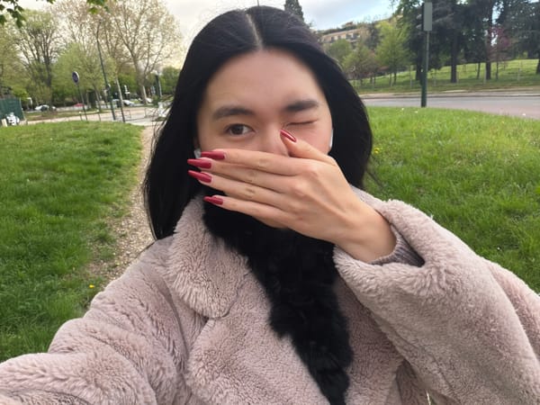 Woman takes playful selfies in Paris park