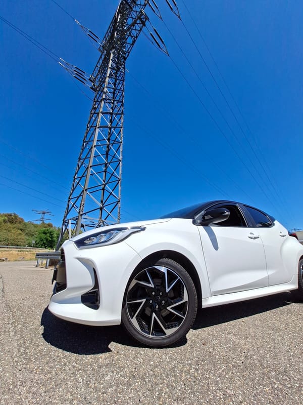 White Toyota Yaris parked under a power pylon near Baden-Baden