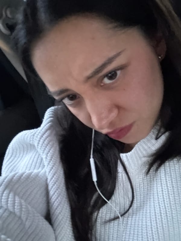 Woman in white sweater listening to music in Puebla
