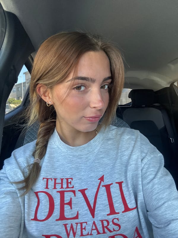 Woman photographed in car wearing graphic sweatshirt in Porto