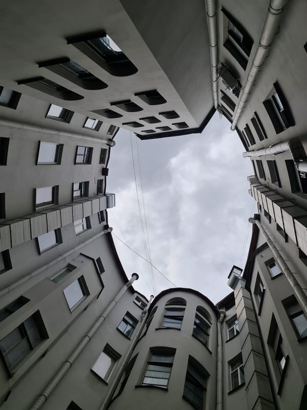 Looking up from a gray Saint Petersburg courtyard