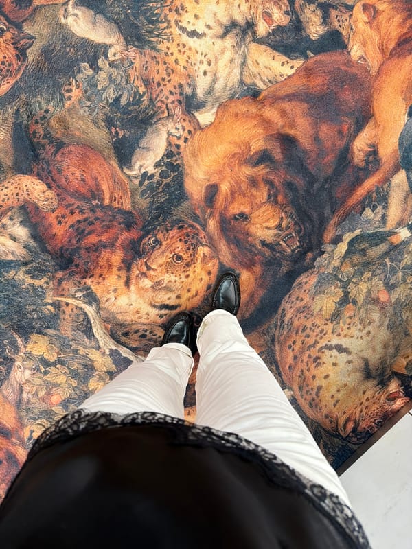 Person stands on ornate animal-patterned rug in Riga