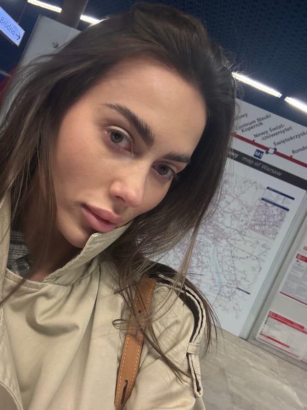 Woman takes selfie at Warsaw metro station as train arrives