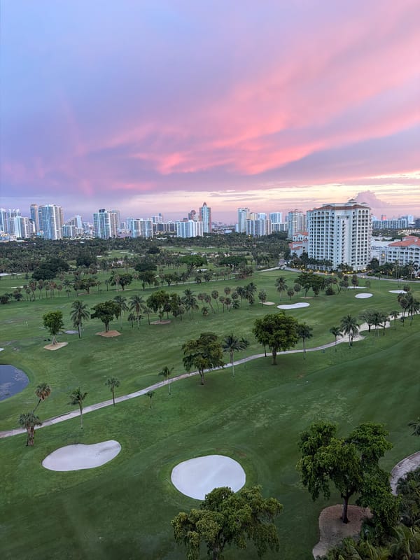 Aerial sunset views over Aventura golf course and skyline