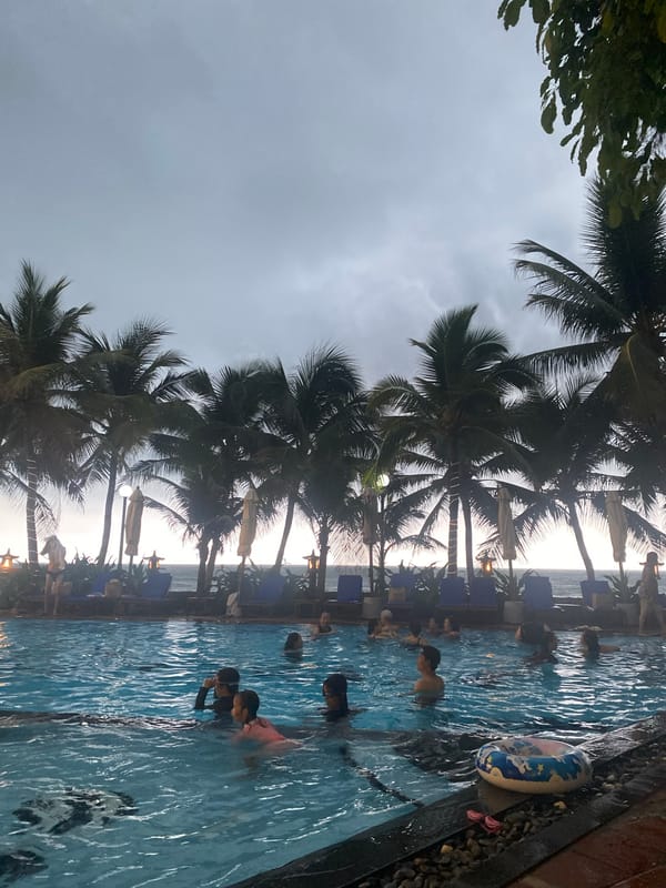 Family enjoys evening swim at Vietnamese resort pool
