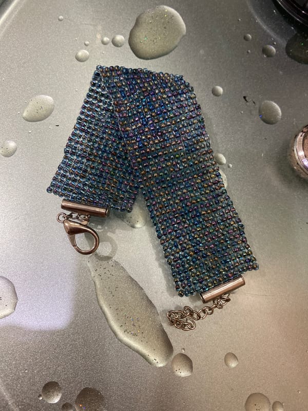Two beaded bracelets, different styles, on metallic surfaces