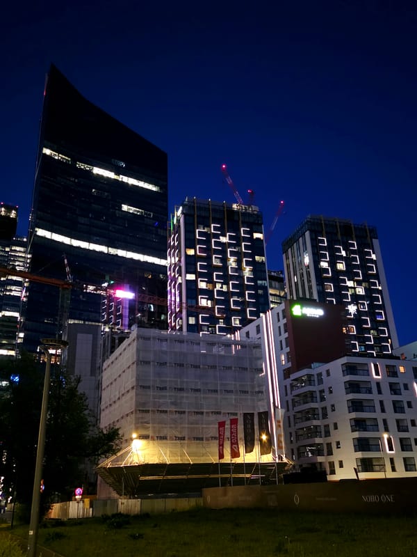 Warsaw business district skyline at dusk, glass towers and construction