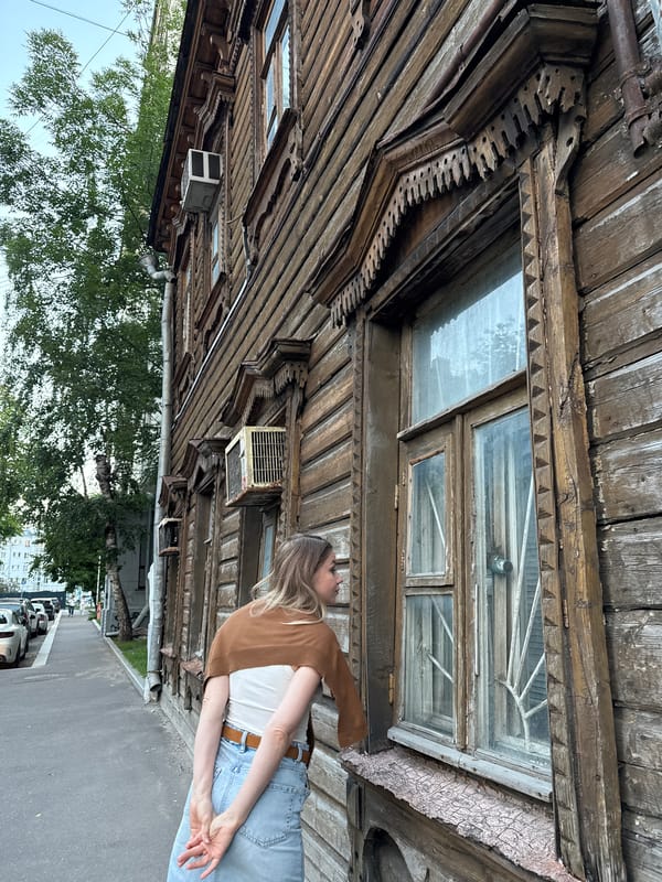 Old carved wooden building on a Moscow street at golden hour