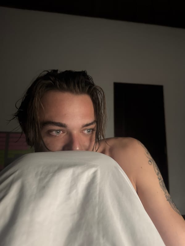 Person photographed with white sheet in Kuta Selatan indoor setting