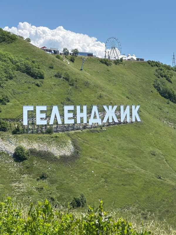Tourist visits Gelendzhik city sign landmark in Russia