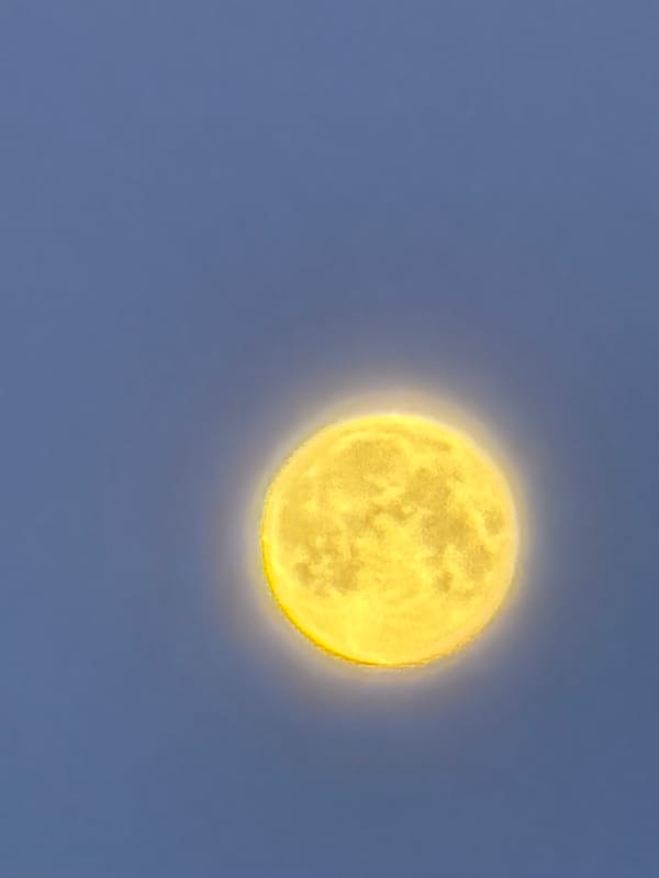 Bright yellow moon with visible craters observed in Krasnoyarsk