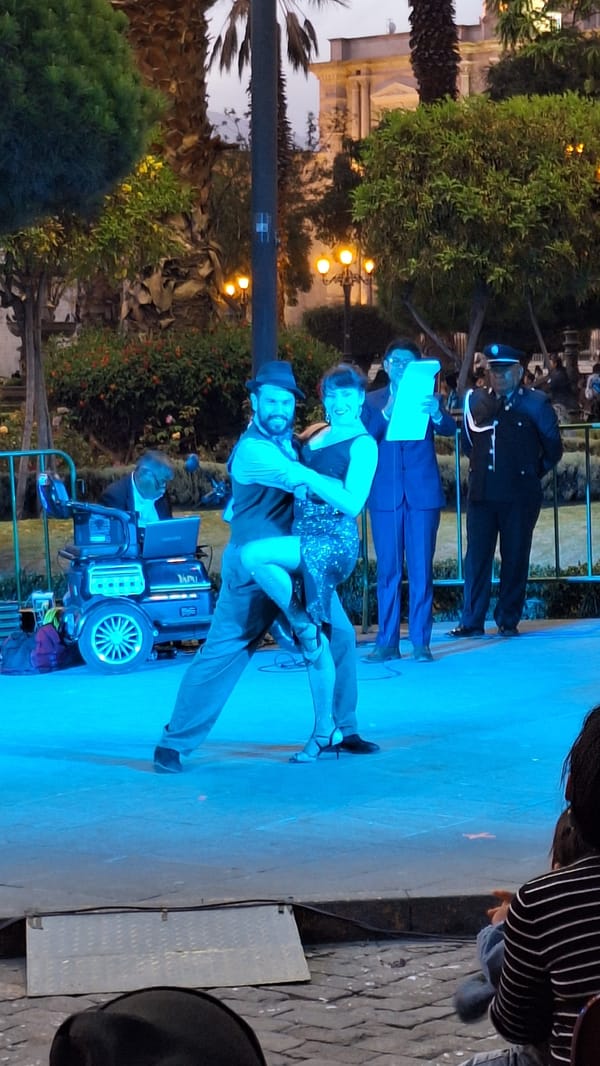 Evening tango performance captured on illuminated stage in Arequipa
