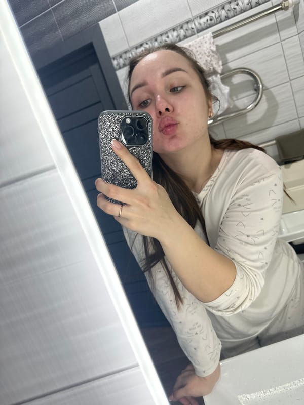 Woman takes morning selfies at home with large dogs