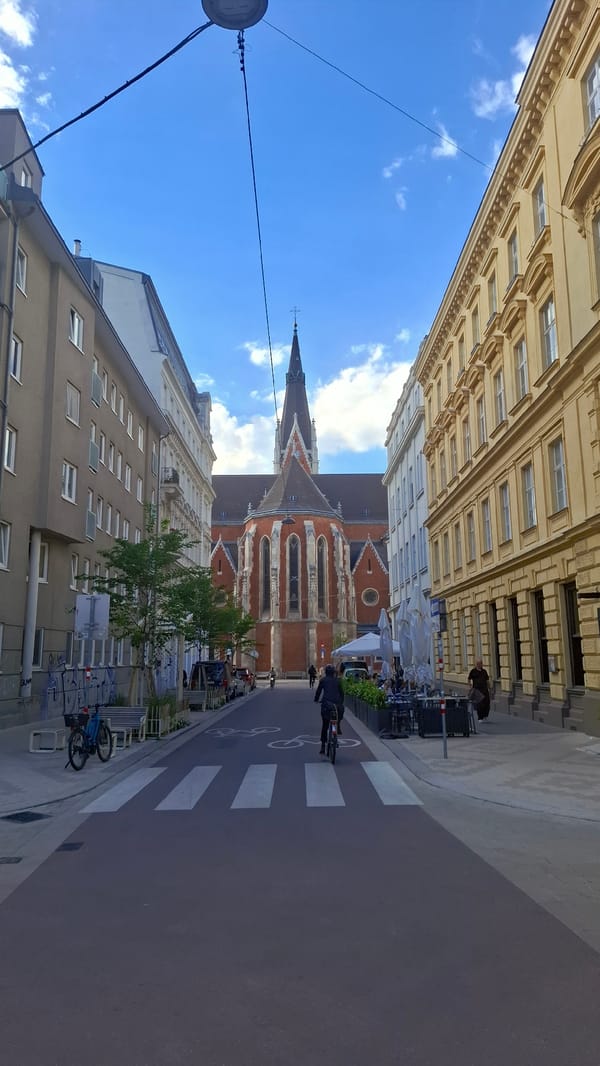 Vienna street scenes captured near Votivkirche with cyclists, pedestrians