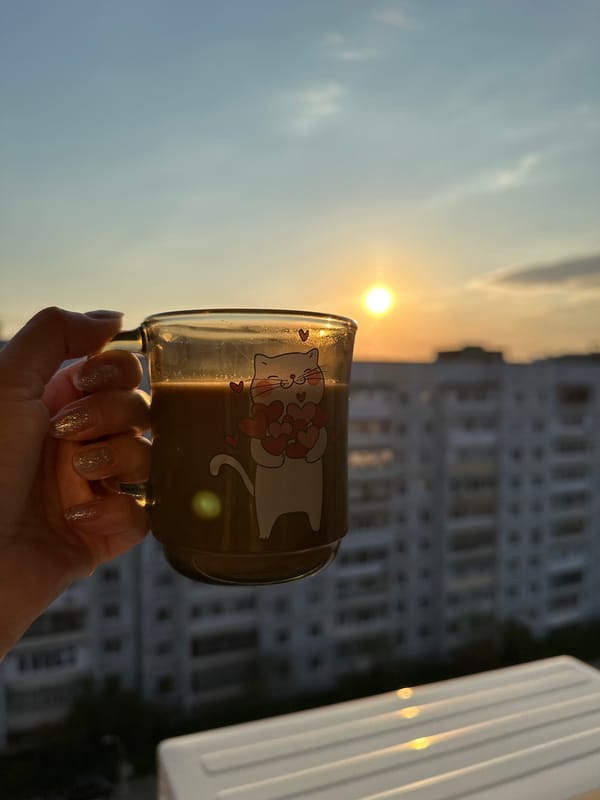 Morning coffee ritual with cat companion documented in Chaikovsky