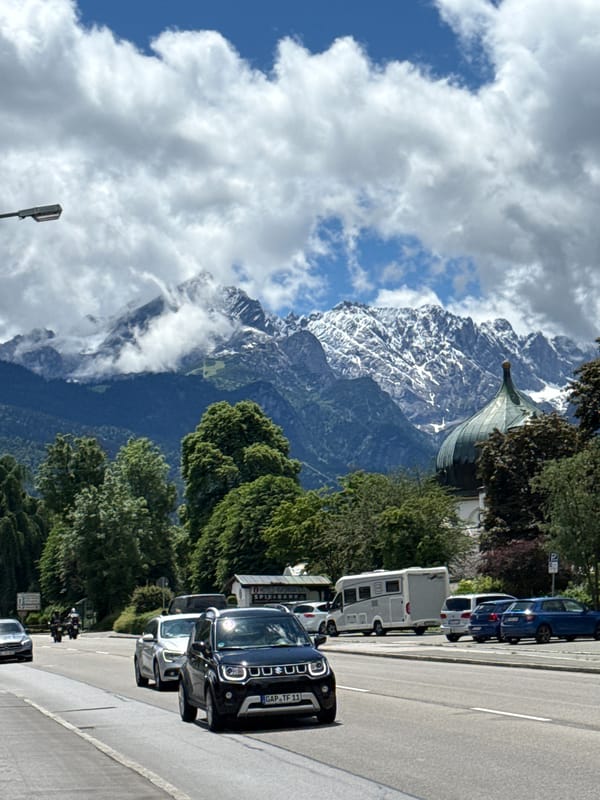 Traffic flows through scenic Garmisch-Partenkirchen beneath Alpine peaks