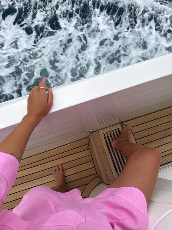 Woman in pink enjoys yacht ride in Montenegro waters